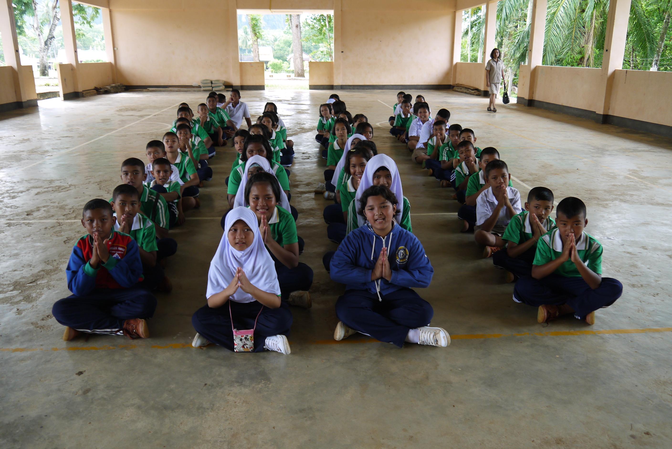 Children attend a workshop run by Projects Abroad volunteers Children listen as schoolies volunteers discuss conserving the environment